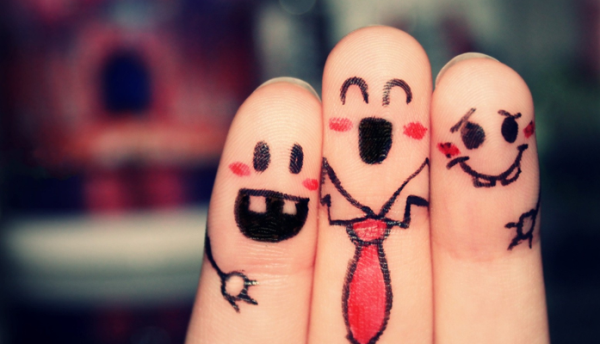 Three fingers with cartoon drawings of faces to represent friends